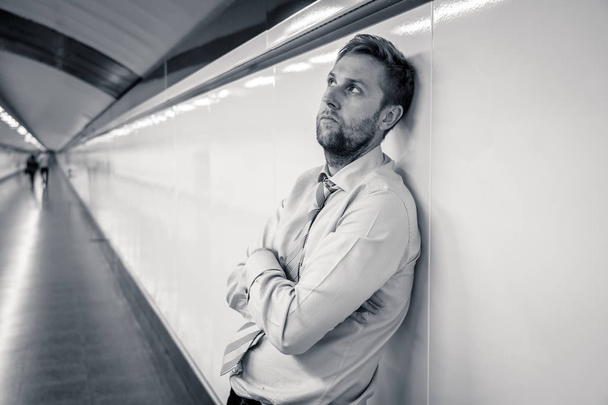 Desperate sad young businessman suffering emotional pain grief and deep depression sitting alone in tunnel subway in Stress life style Work problems failure Unemployment Mental health and Depression. - Fotografie, Obrázek