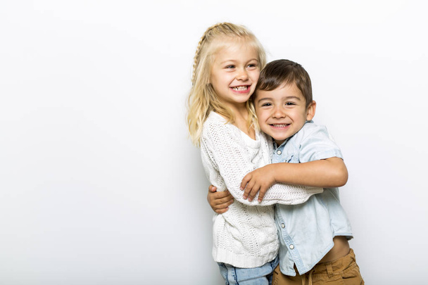 Cute girl 4-5 year old with brother posing in studio - Photo, image