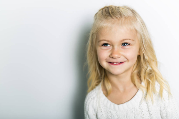 A Cute girl 5 year old posing in studio - Фото, изображение