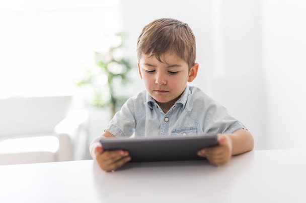 little boy with tablet on the kitchen - Photo, image