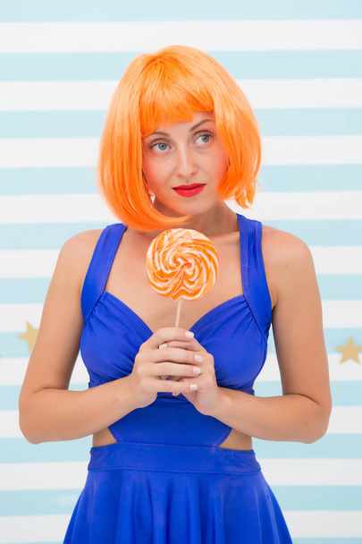 Crazy girl in playful mood. Fashion girl with orange hair having fun. happy pinup model with lollipop in hand. Cool girl with lollipop. Sexy woman. thinking. sweet dreams. party time. - Fotoğraf, Görsel