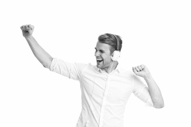 Dancing music. Man listening favourite song in headphones and dancing. Man happy face enjoy listening music radio isolated white background. Guy with earphones dancing while listening music - Foto, Bild