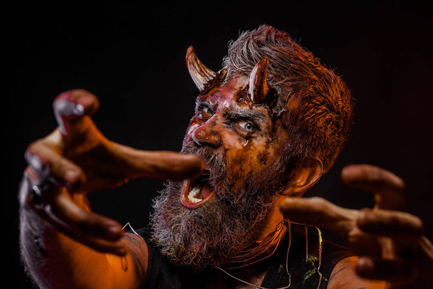 Halloween man demon hipster with horns stretch zombie hands - Foto, Bild