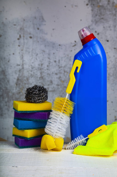 Items for home or office cleaning on the background of a gray wall. - Photo, Image