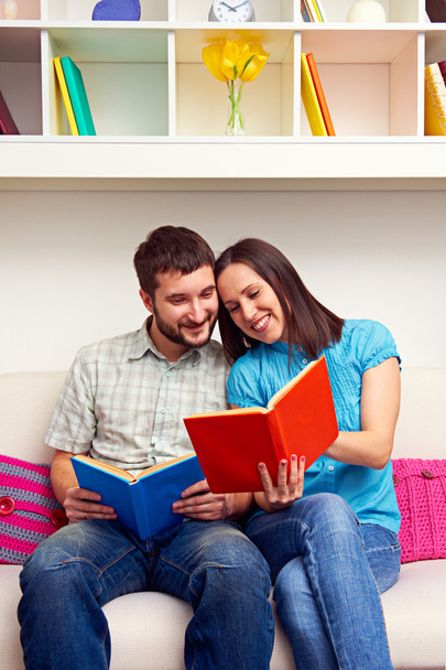 couple sitting on sofa and reading the book - Photo, Image