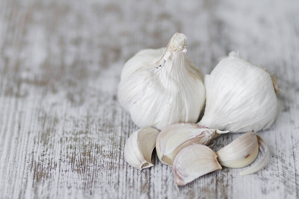 White garlic cloves over a rustic background - Fotó, kép