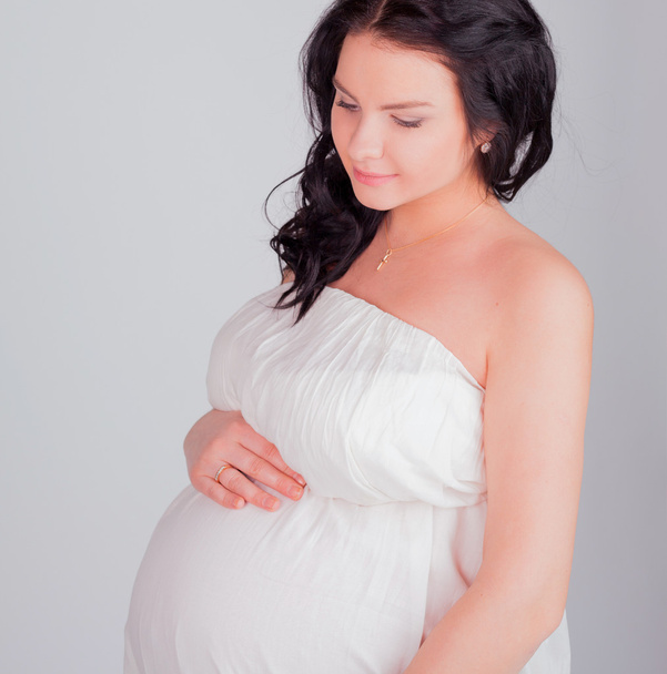 pregnant woman in a white dress - Foto, immagini
