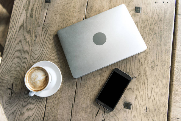 vue du dessus de tasse de café avec smartphone et ordinateur portable sur table en bois rustique
 - Photo, image