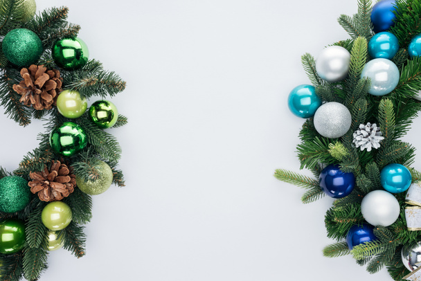 top view of pine tree wreathes with green, blue and silver christmas balls isolated on white - Фото, зображення