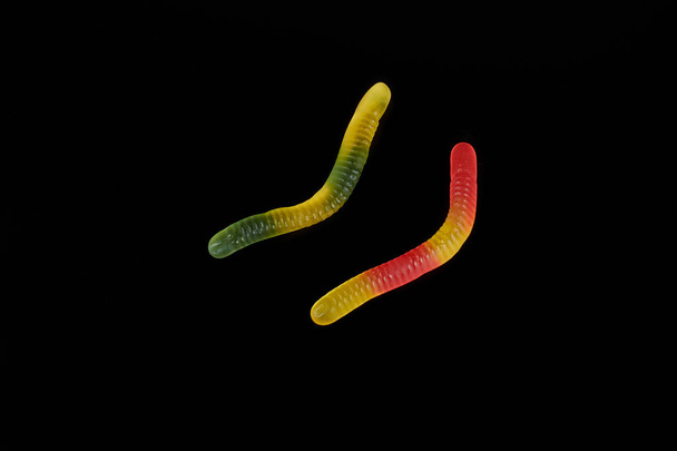 gummy jelly worm candy on a black background. - 写真・画像