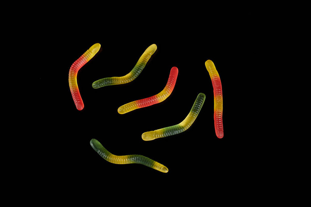 gummy jelly worm candy on a black background. - Foto, afbeelding