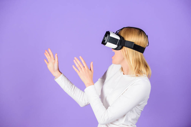 Girl use modern technology vr headset. Interact alternative reality. Digital device and modern opportunities. Woman head mounted display violet background. Virtual reality and future technologies - Photo, image