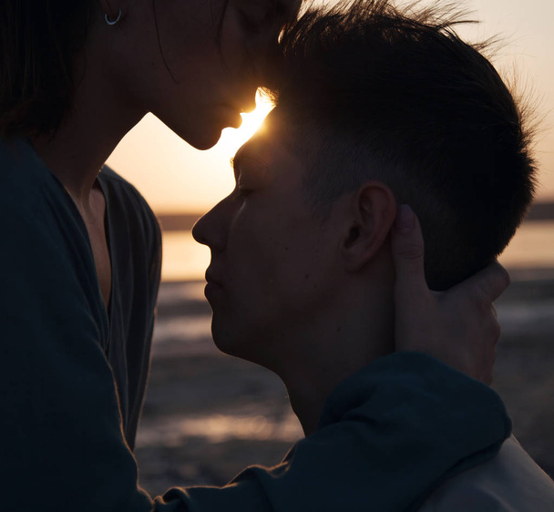 Beautiful tender couple on the background of the sunset. - Photo, Image