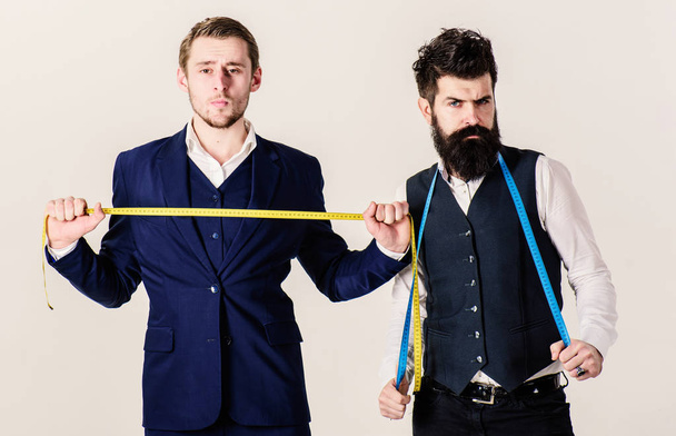 Tailors on strict faces with measuring tapes on neck - Fotoğraf, Görsel