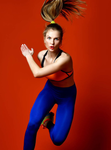 Runner woman isolated. Running fit fitness sport model jogging on red background.  - Foto, Imagem