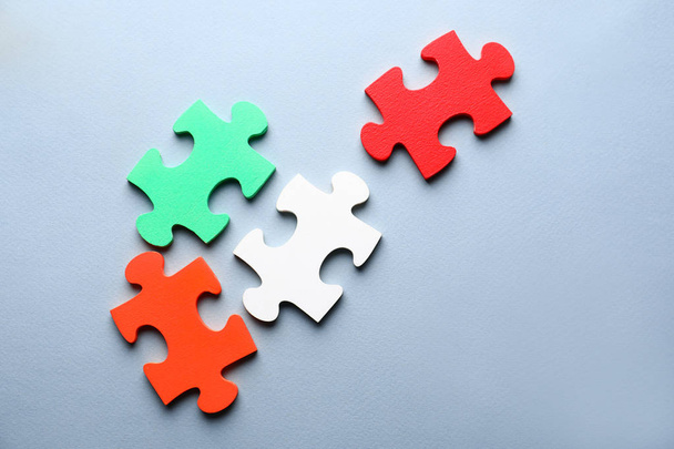Pieces of puzzle on color background - Foto, immagini