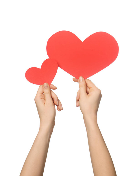 Woman holding red hearts on white background - Photo, Image
