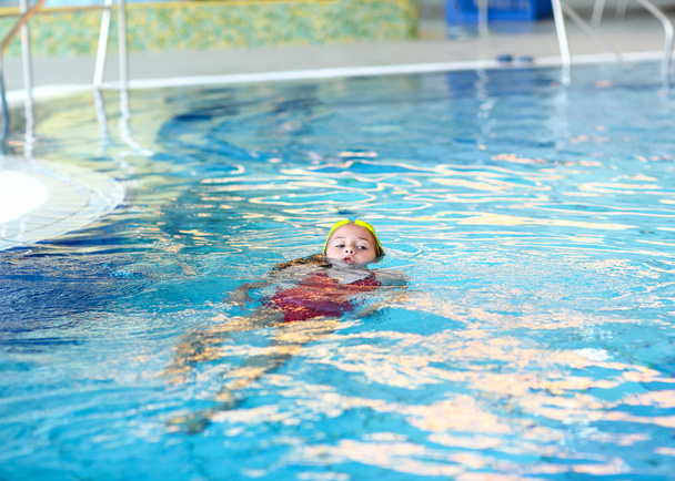kind zwemmen rugslag - Foto, afbeelding
