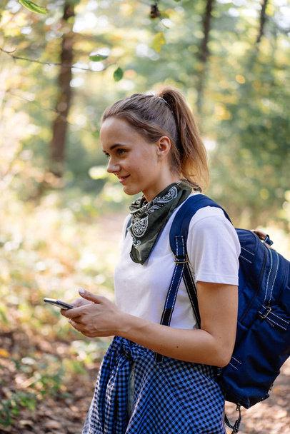 Young woman using navigation in phone on hiking - Fotoğraf, Görsel