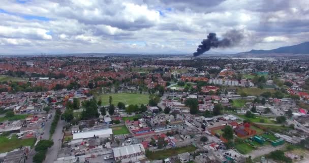 Tultitlan, Mexico. CIRCA OCTOBER 2018. Panoramic view of a fire that destroy a liquor factory in a industrial zone. A large black smoke column rises in the distance. - Footage, Video