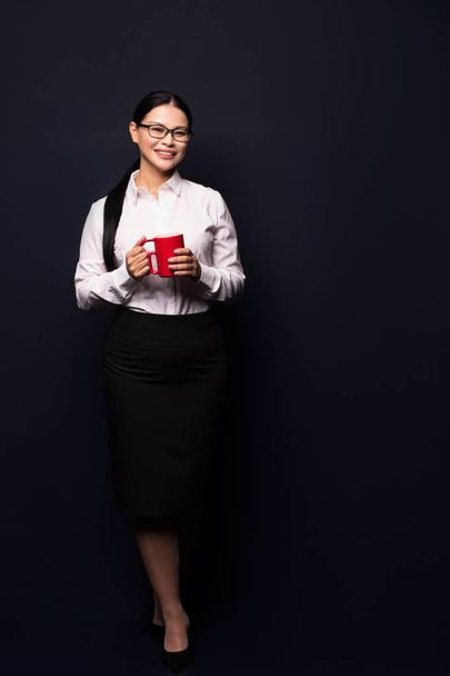 Businesswoman enjoying coffee break holding red cup - Zdjęcie, obraz
