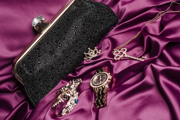 set of women's accessories on a silk background - Fotoğraf, Görsel