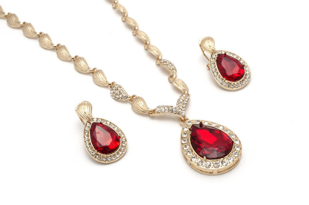 set of gold earrings and a necklace with a ruby isolated on white - Photo, Image