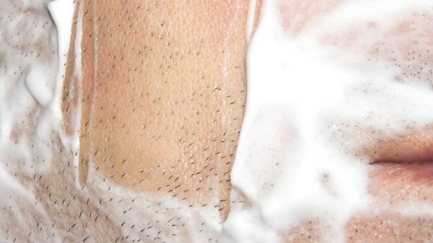 A man shaves the machine.Background shave with shaving cream. - Valokuva, kuva