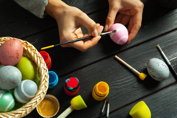 preparing for Easter, woman painting eggs - Fotó, kép