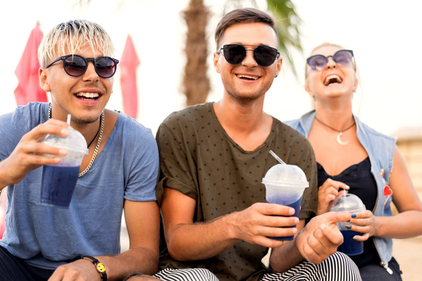 three friends on the beach drinking cocktails fun - Fotografie, Obrázek