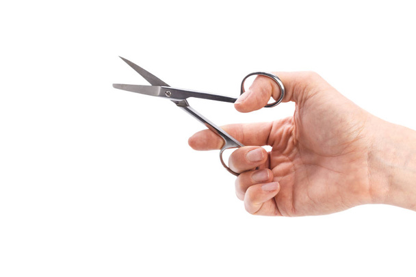 Female hand holding scissors, isolated on white background - Фото, изображение
