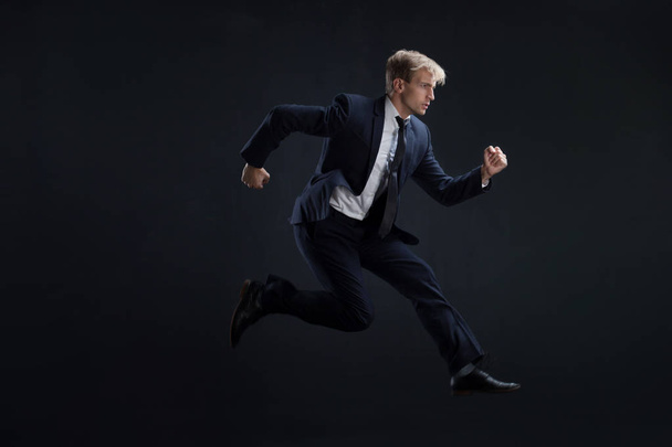 Fast business. Running businessman in business suits, concept - Zdjęcie, obraz