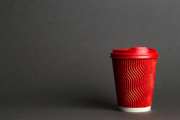 coffee to go in a disposable cup on a black background, place for tex - Фото, зображення