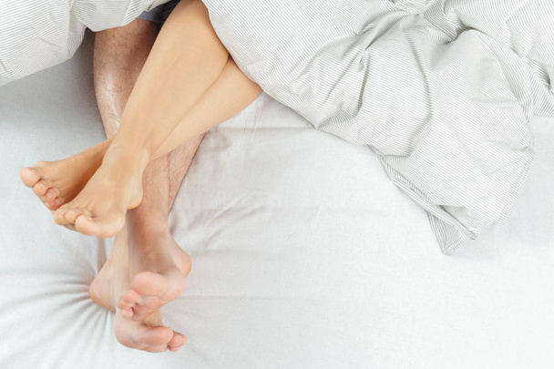 beautiful couple lying together on the bed - 写真・画像