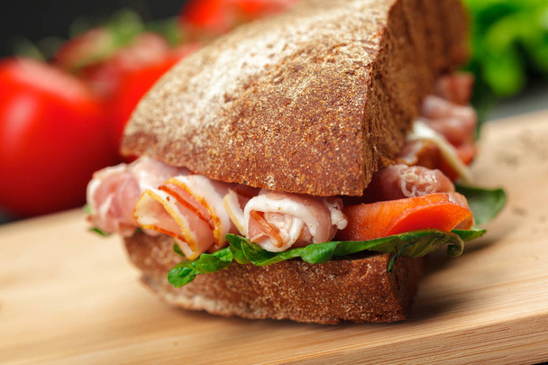 close up of delicious sandwich on a wooden table - Foto, Bild