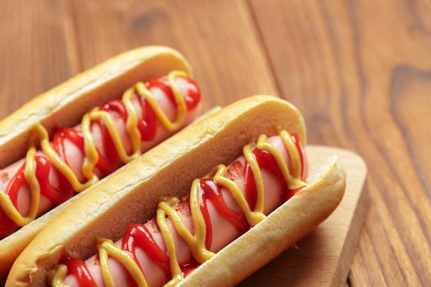 close up of Hot dogs on wooden background - Photo, image