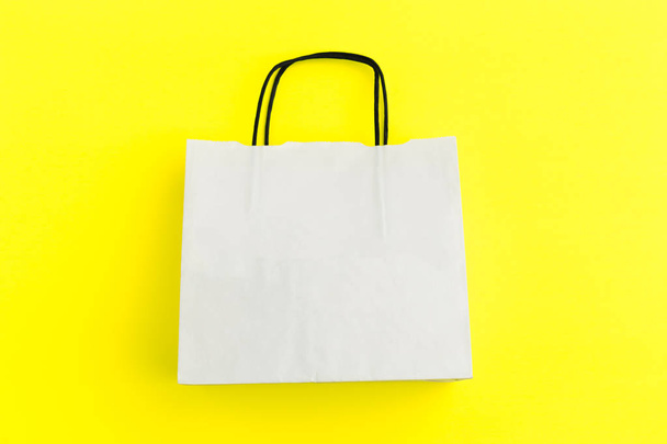 paper shopping bag on colorful background - 写真・画像