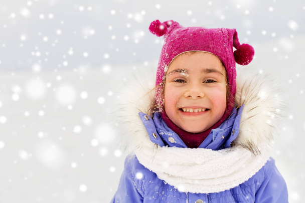 happy little girl in winter clothes outdoors - Fotó, kép