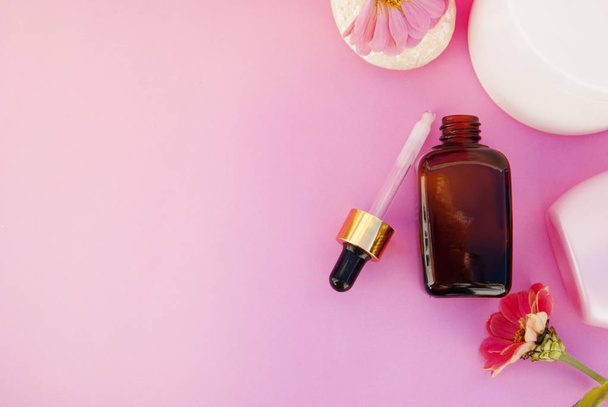 Beauty spa cosmetics, salon therapy concept. Glass cosmetic bottle on pink background. - Fotografie, Obrázek