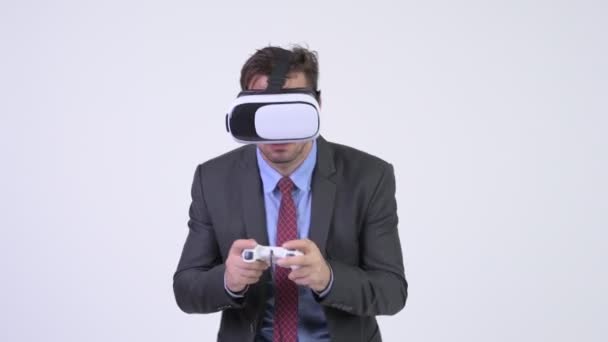 Young Hispanic businessman playing games and using virtual reality headset - Footage, Video