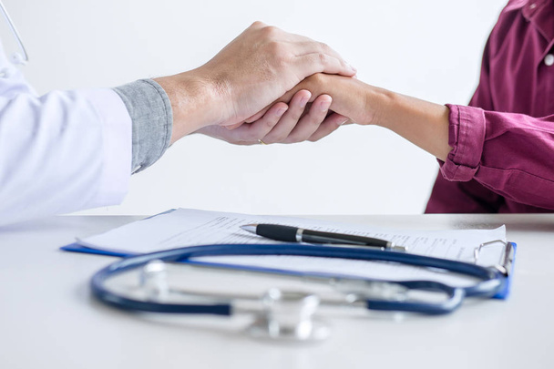 Doctor touching patient hand for encouragement and empathy on the hospital, cheering and support patient, medical examination, trust and ethics. - Foto, Imagem