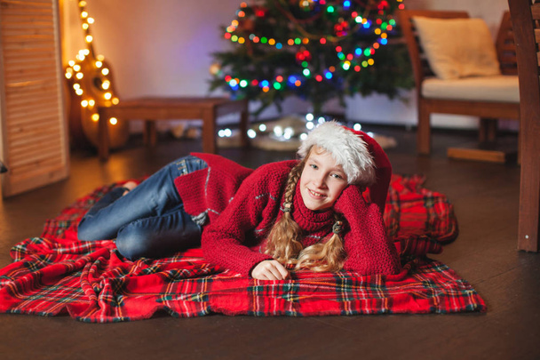 Smiling girl near christmas tree at home - Valokuva, kuva