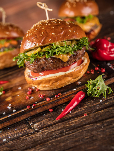 Delicious hamburger with fries, served on wood. Free space for text - Foto, imagen