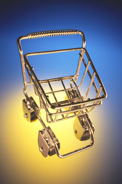 Miniature Shopping Trolley on Blue Background - Foto, immagini