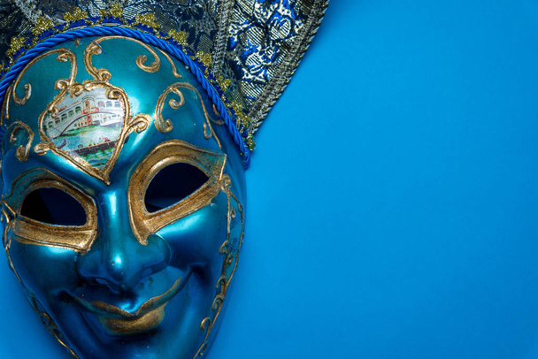 Blue Mardi Gras or carnival jester mask on a blue background - Photo, Image