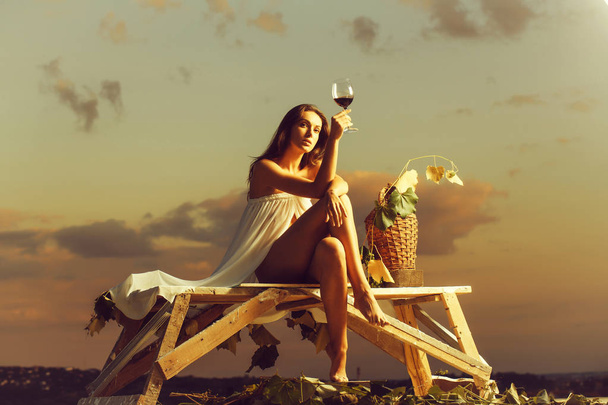 pretty woman with wine over sky - Φωτογραφία, εικόνα
