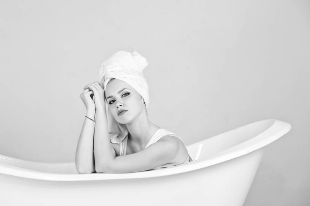woman in towel sitting in bath tub - Photo, image