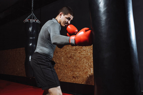Boxer hits a speed bag in the gym - Fotó, kép