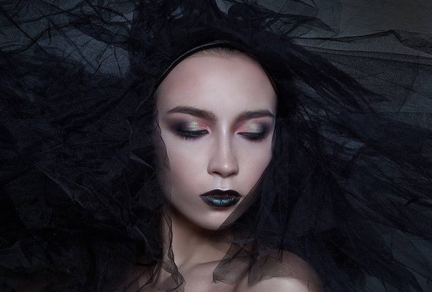 High Fashion Model meisje portret met Trendy gotische zwart Make up, donkere portret. Halloween vampier vrouw met Zwarte matte lippen over diep blauwe achtergrond. model meisje gezicht met zwarte lippenstift make-up. - Foto, afbeelding
