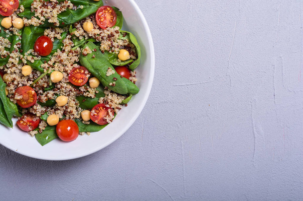 Spinach salad with quinoa , tomatoes and chickpea . Healthy vegan superfood - Photo, Image